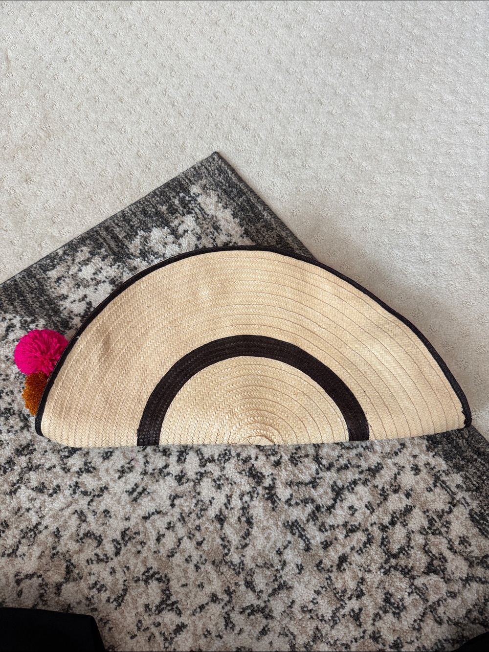 Half-Moon Straw Clutch with Black Trim and Colorful Pom Poms